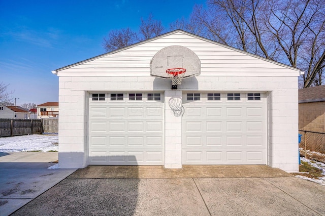 detached garage featuring fence