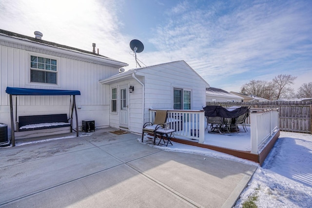 snow covered property with fence