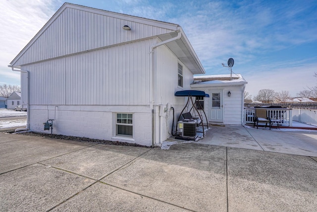 view of home's exterior with cooling unit and a patio