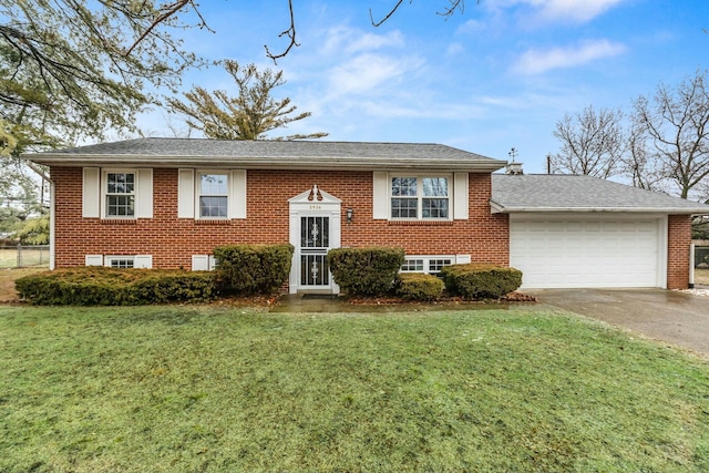 bi-level home featuring a garage and a front yard