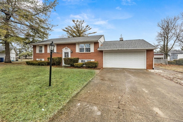 split foyer home featuring a garage and a front lawn