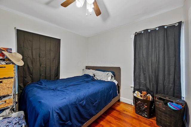 bedroom featuring wood-type flooring and ceiling fan