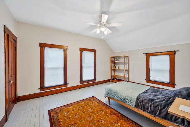 bedroom featuring ceiling fan, lofted ceiling, and light hardwood / wood-style floors