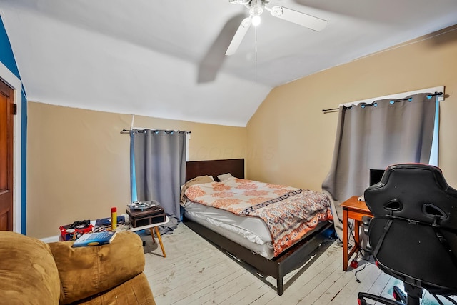 bedroom featuring ceiling fan, lofted ceiling, and light hardwood / wood-style floors