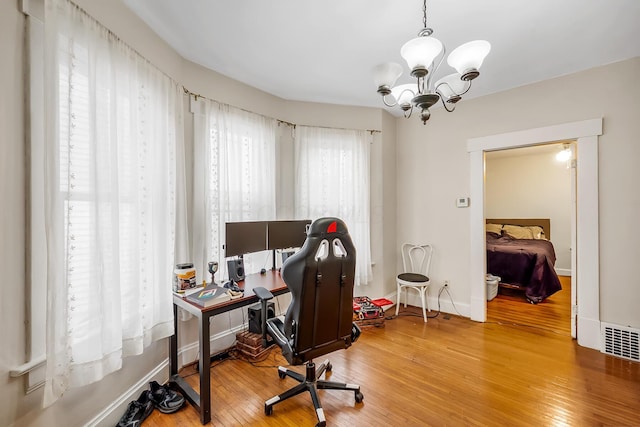 office space featuring hardwood / wood-style flooring and a chandelier