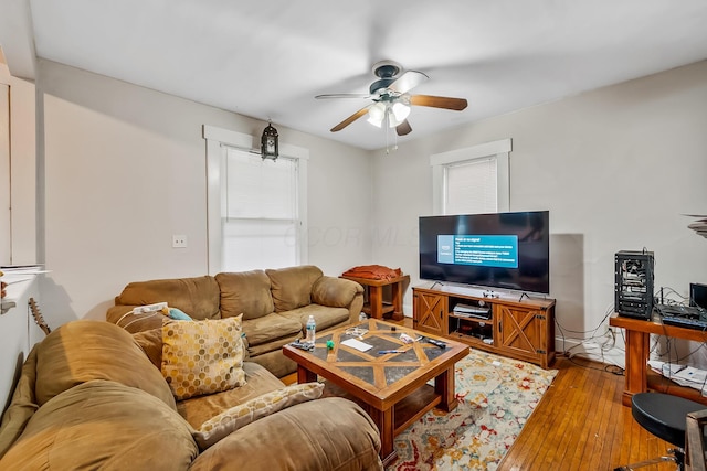 living room with light hardwood / wood-style flooring and ceiling fan