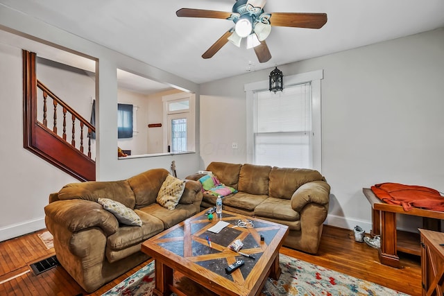 living room featuring ceiling fan and hardwood / wood-style floors