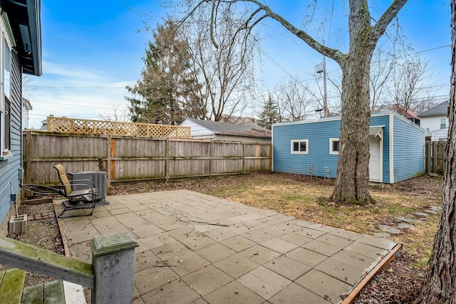 view of patio featuring cooling unit and an outbuilding