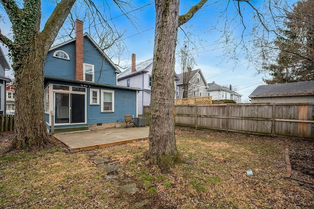 rear view of house featuring central AC unit and a patio