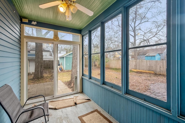 unfurnished sunroom featuring plenty of natural light and ceiling fan