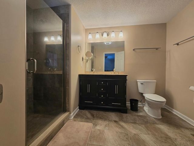 bathroom with an enclosed shower, a textured ceiling, and toilet