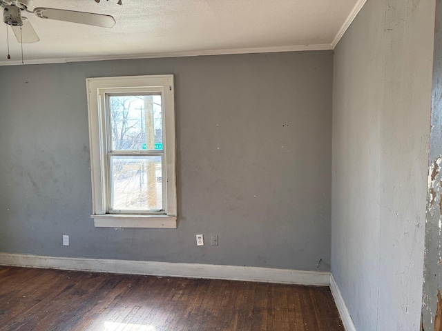 empty room featuring crown molding, dark wood-type flooring, a textured ceiling, and ceiling fan