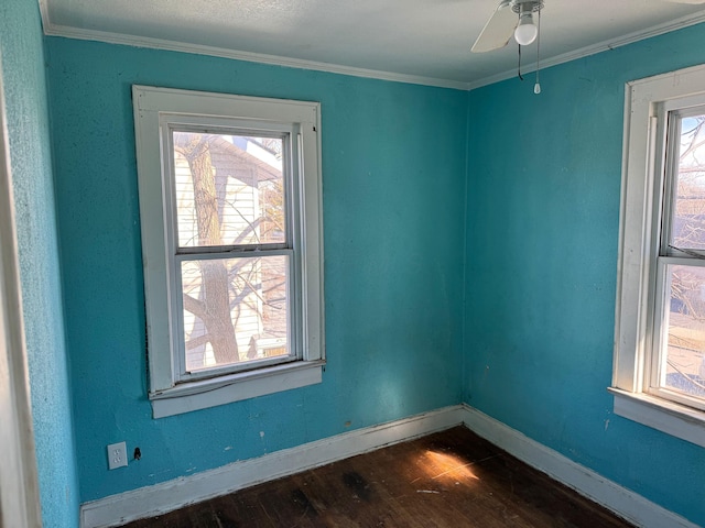 unfurnished room featuring ceiling fan, ornamental molding, and dark wood-type flooring