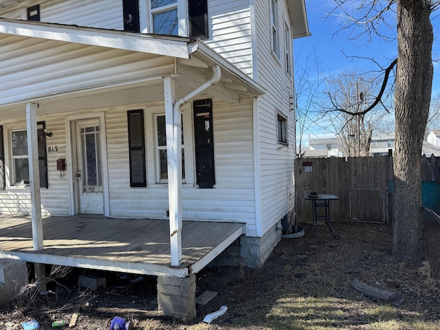 view of side of home with covered porch