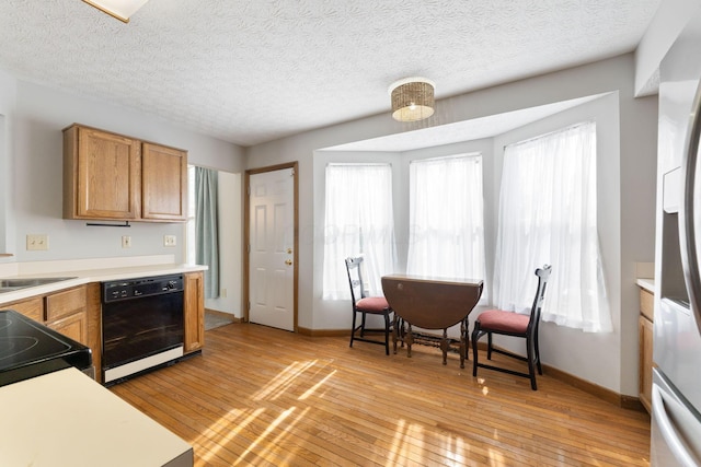 kitchen with brown cabinets, stainless steel refrigerator with ice dispenser, light countertops, and dishwasher