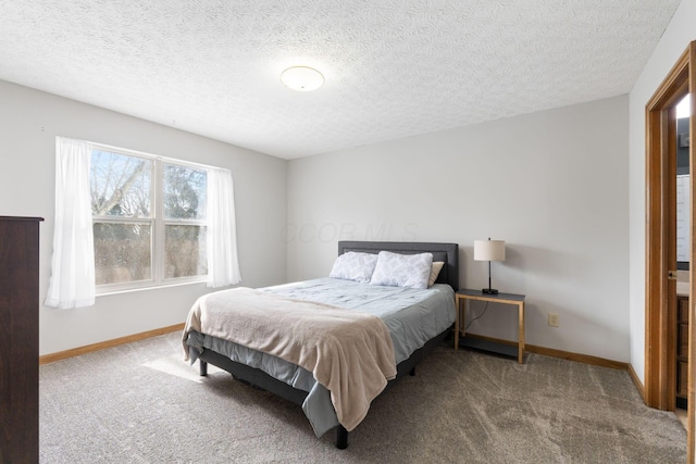 carpeted bedroom featuring a textured ceiling and baseboards