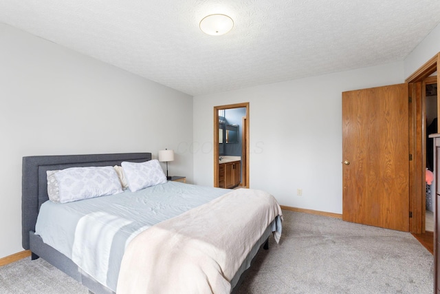 bedroom featuring a textured ceiling, carpet floors, and baseboards