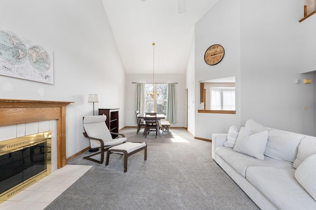 living area featuring high vaulted ceiling, light colored carpet, a fireplace, and baseboards