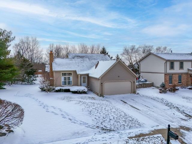 view of front of property with an attached garage and a chimney