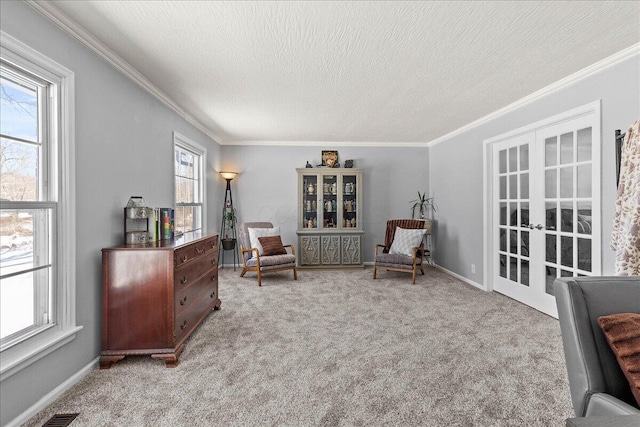 living area featuring ornamental molding, a textured ceiling, french doors, carpet flooring, and baseboards