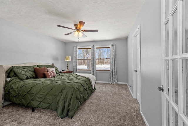 carpeted bedroom featuring ceiling fan, a textured ceiling, and baseboards