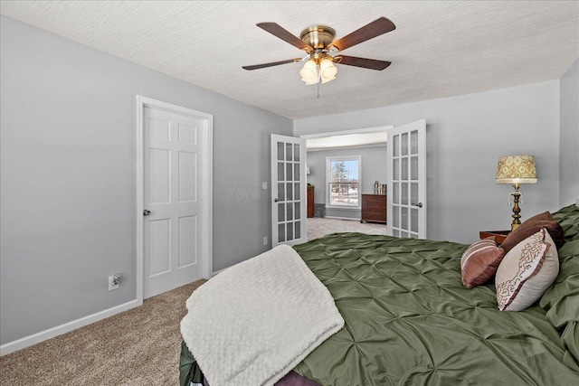 carpeted bedroom with french doors, baseboards, a textured ceiling, and ceiling fan