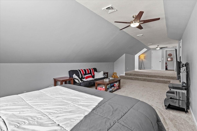 carpeted bedroom featuring visible vents, lofted ceiling, and a ceiling fan