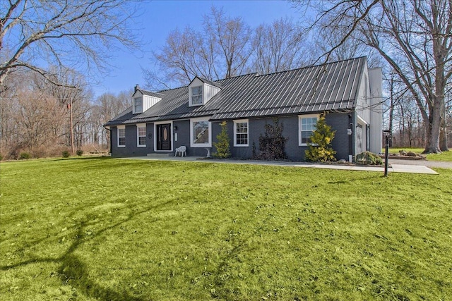 cape cod-style house with a front yard, brick siding, and metal roof