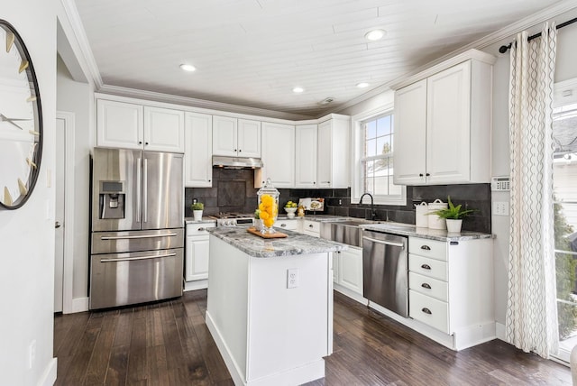 kitchen featuring white cabinetry, appliances with stainless steel finishes, a sink, and a center island