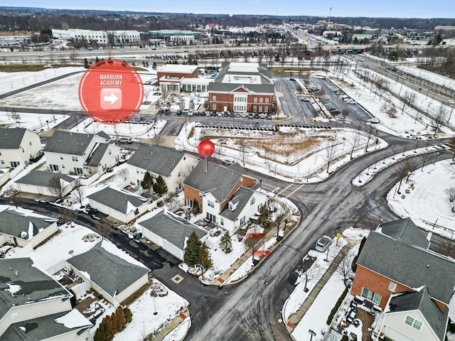 snowy aerial view with a residential view