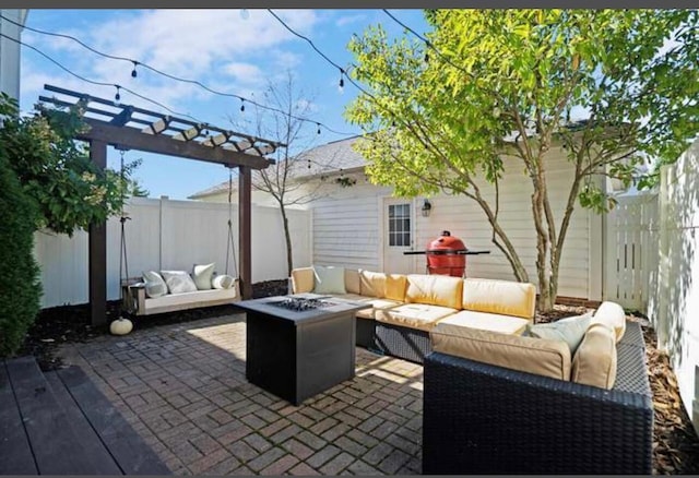 view of patio with an outdoor living space with a fire pit and a fenced backyard