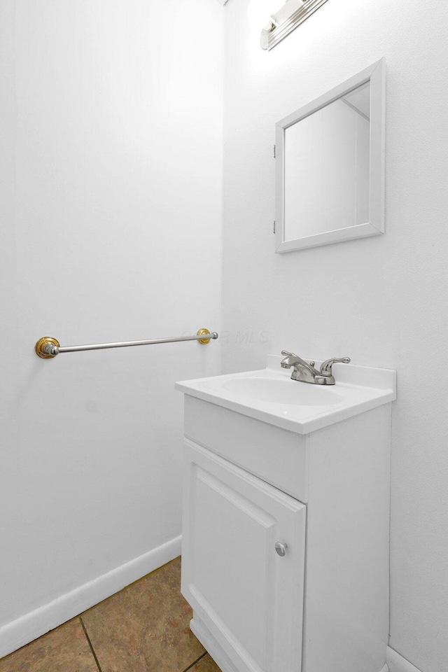 bathroom with tile patterned floors, baseboards, and vanity