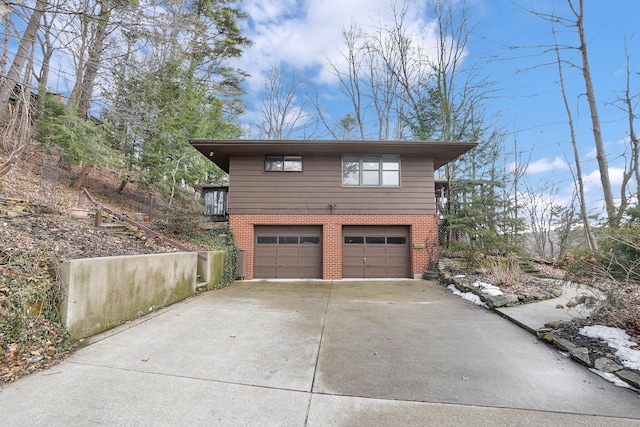 garage featuring concrete driveway