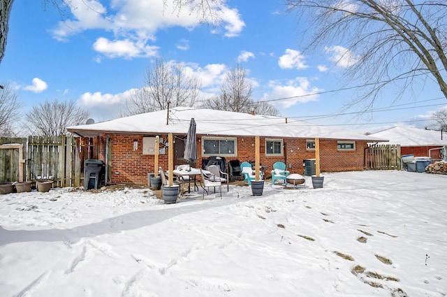 view of snow covered rear of property