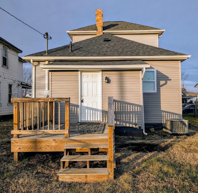 rear view of house with a deck and central AC unit