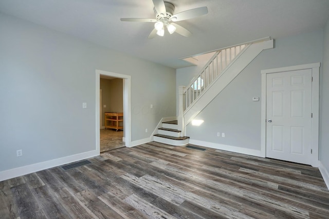 empty room with ceiling fan and dark wood-type flooring