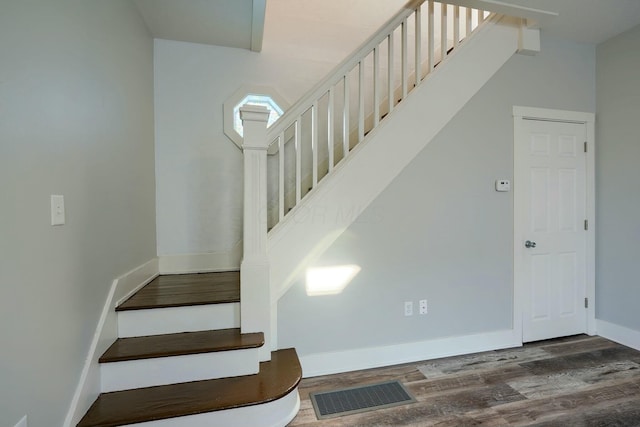 stairs featuring wood-type flooring