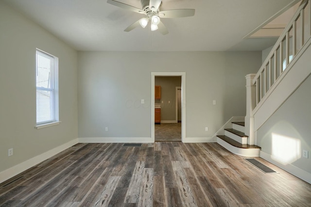 empty room featuring ceiling fan and dark hardwood / wood-style flooring