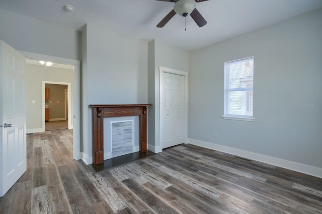 interior space featuring ceiling fan, a closet, and dark hardwood / wood-style flooring