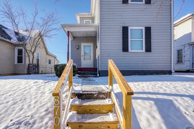 view of snow covered property entrance