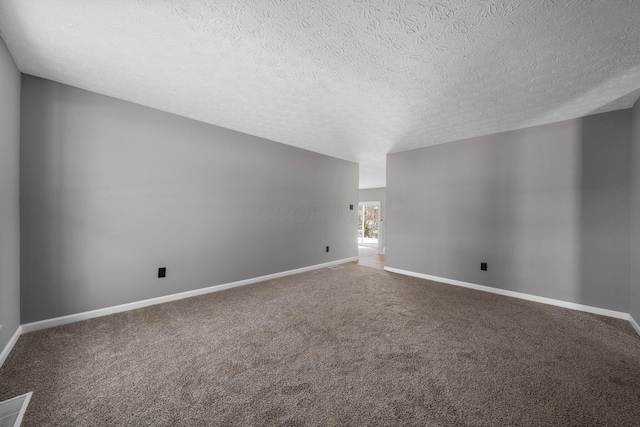 spare room featuring carpet flooring and a textured ceiling