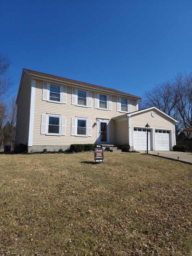 view of front of home featuring an attached garage, concrete driveway, and a front lawn