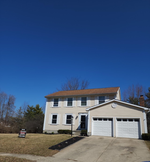 view of front of house with a garage, a front yard, a chimney, and driveway