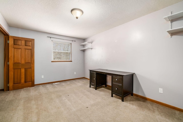 home office with carpet flooring, a textured ceiling, and baseboards