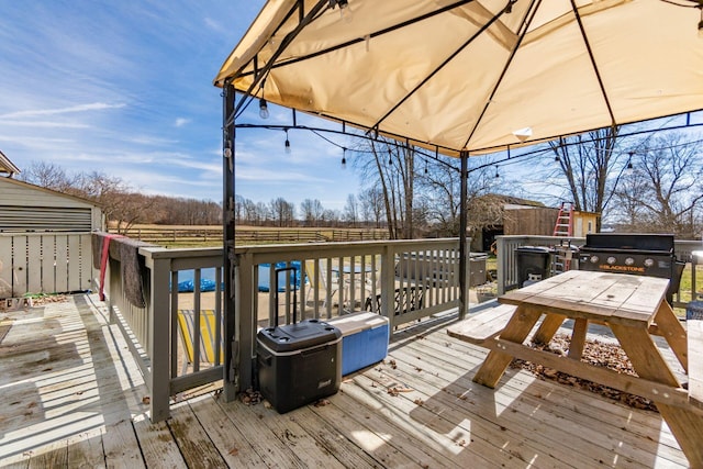 wooden deck with a grill