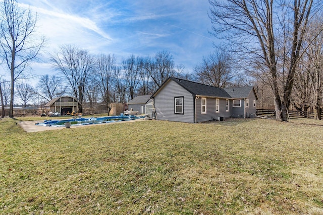 view of property exterior with a lawn, fence, and a fenced in pool