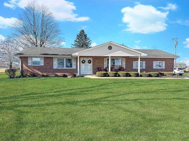 ranch-style house with brick siding and a front yard