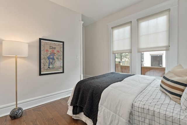 bedroom featuring wood finished floors and baseboards