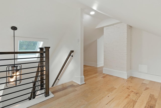 additional living space with lofted ceiling, recessed lighting, wood finished floors, and baseboards