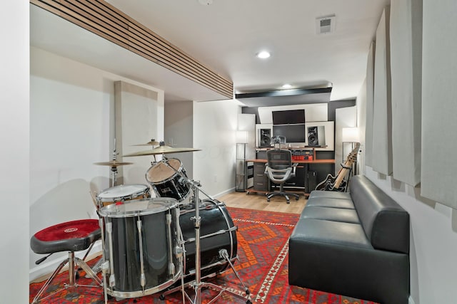 living room with recessed lighting, wood finished floors, visible vents, and baseboards